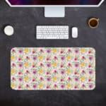 White desk mat with a medium-sized floral pattern in pink, yellow, and purple flowers, adding a vibrant and creative touch to your desk. Desk Mat with a computer