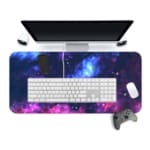 Infidu Space Desk Pad features a vivid, colorful nebula with swirling clouds of gas and dust in blue, pink, purple, and orange hues. Desk Mat with a computer