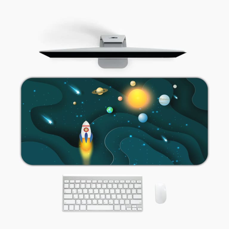 Infidu Space Desk Pad featuring a rocket launch, planets, and stars on a dark teal background. Desk Mat with a computer