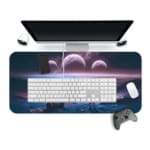 Infidu Space Desk Pad shows a person on a cliff overlooking an alien planet with multiple moons, set against a dark black space background. Desk Pad with Keyboard and Mouse