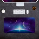 Infidu Space Desk Pad features a nebula with rich purples, blues, and pinks, set against a field of stars and cosmic clouds. Desk Pad kept on a gray background