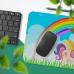 Infidu Unicorn Desk Mat features a colorful forest scene with a unicorn, rainbow, and blue sky, perfect for adding magic to your desk. Desk Pad with Keyboard and Mouse