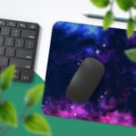 Infidu Space Desk Pad features a vivid, colorful nebula with swirling clouds of gas and dust in blue, pink, purple, and orange hues. Desk Pad with Keyboard and Mouse