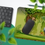 Infidu Explore Nature Desk Mat features a colorful forest scene with a bird, elephant, monkey, and a lively green and brown background. Desk Pad with Keyboard and Mouse