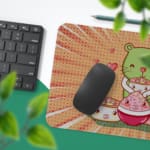 Infidu Bring Cat Magic Desk Mat featuring a cute cat with a green and blue face, surrounded by hearts and a playful radial burst background. Desk Pad with Keyboard and Mouse