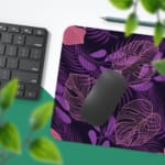 Stylized leaf patterns in lighter shades of purple and pink on the Infidu Bring the Beauty of Flowers Desk Pad with Keyboard and Mouse