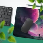 Infidu Space Desk Pad features an abstract alien landscape with geometric rock formations and multiple planets on a pink and green background. Desk Pad with Keyboard and Mouse