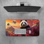 Cute panda on a rock surrounded by pink flowers and a sunset sky with orange, pink, and purple hues. Desk Pad with Keyboard and Mouse on top of the desk pad