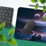 Infidu Space Desk Pad shows a person on a cliff overlooking an alien planet with multiple moons, set against a dark black space background. Desk Pad with Keyboard and Mouse