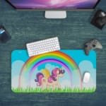 Infidu Unicorn Desk Mat features a colorful forest scene with a unicorn, rainbow, and blue sky, perfect for adding magic to your desk. Desk Pad with Design Kept on a computer table