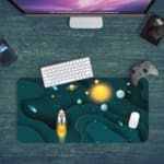 Infidu Space Desk Pad featuring a rocket launch, planets, and stars on a dark teal background. Desk Pad with Keyboard and Mouse in green background