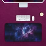 Infidu Space Desk Pad features a nebula scene with rich purples, blues, and a splash of pink, surrounded by stars and cosmic clouds. Desk Pad with Keyboard and Mouse