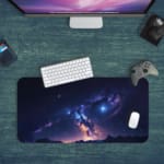 Infidu Space Desk Pad features a deep space view with a star cluster, nebulae, and a bright spot fading into dark blue and purple edges. Desk Pad kept on a green background