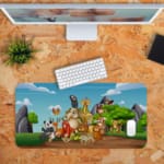 Infidu Explore Nature Desk Mat features a vibrant anime design with animals, trees, and mountains in orange and other colors, perfect for children's desks Desk Pad kept on a plain orange background