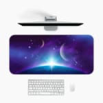 Infidu Space Desk Pad features a nebula with rich purples, blues, and pinks, set against a field of stars and cosmic clouds. Desk Mat with a computer