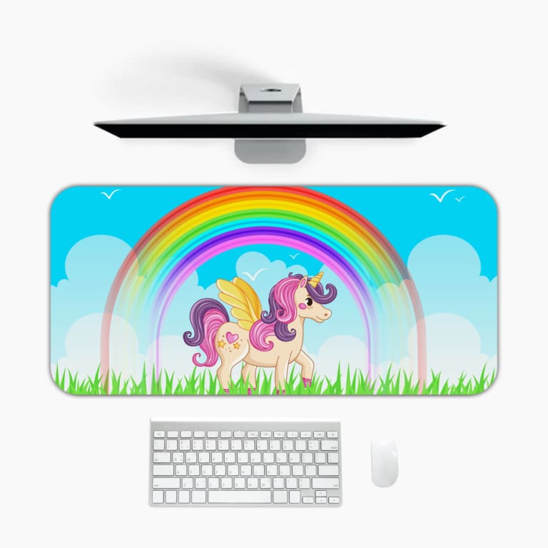 Infidu Unicorn Desk Mat features a colorful forest scene with a unicorn, rainbow, and blue sky, perfect for adding magic to your desk. Desk Pad on the computer table