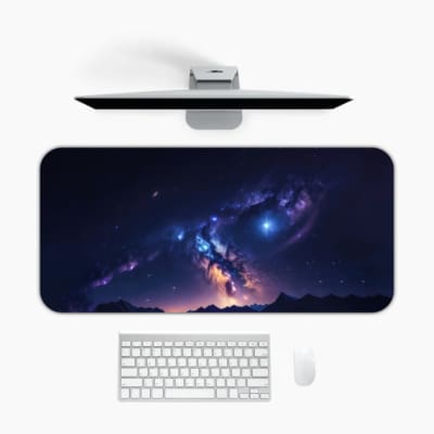 Infidu Space Desk Pad features a deep space view with a star cluster, nebulae, and a bright spot fading into dark blue and purple edges. Desk Mat with a computer