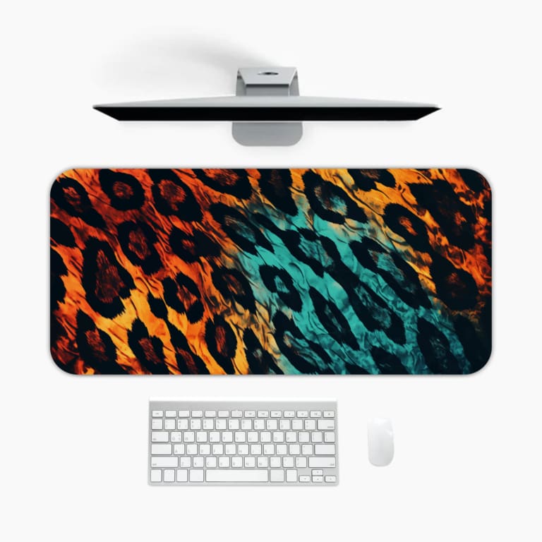 Infidu Vibrant Leopard Print Desk Pad featuring a brown and yellow leopard pattern transitioning to blue and black. A desk pad under the computer