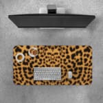 Infidu Light Beige Desk Pad with dark brown leopard print spots. Desk Pad with Keyboard and Mouse on top of the desk pad