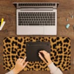 Infidu Light Beige Desk Pad with dark brown leopard print spots. A writing pad on top of the desk pad