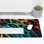 Infidu Vibrant Leopard Print Desk Pad featuring a brown and yellow leopard pattern transitioning to blue and black. Desk Pad with Keyboard and Mouse on top of the desk pad