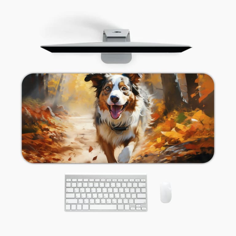 Border Collie running through an autumn forest with warm colors and fallen leaves. A desk pad under the computer