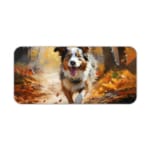 Border Collie running through an autumn forest with warm colors and fallen leaves. Desk Pad kept on a plain white background