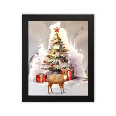 Christmas wall art featuring a white tree with red ornaments, gifts underneath, a reindeer, and a snowy background in a watercolor style. displayed on the plain white background in a black frame