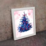 Pink stocking Christmas wall art with red accents, green leaves, berries, and a starry pink background. on the wall in a white frame