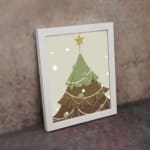 Christmas tree illustration with white ornaments, light gray background, snowflakes, and a dark frame. on the wall in a white frame