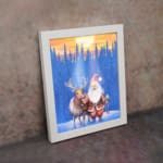 Christmas wall art with a colorful, patterned background featuring festive designs. on the wall in a white frame