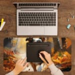 Border Collie running through an autumn forest with warm colors and fallen leaves. A writing pad on top of the desk pad