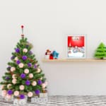 Santa Claus flying in a sleigh with reindeer against a red background, full moon, and snowy village. displayed on the table in a white frame