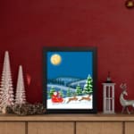 Santa Claus in a red sleigh with reindeer flying through a snowy winter landscape under a full moon. displayed on the table in black frame