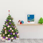 Santa Claus in a red sleigh with reindeer flying through a snowy winter landscape under a full moon. displayed on the table in white frame