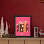 Infidu Gift Box Art - Festive Design with Snowflakes and Ribbon Print with brown polka dot gift box, pink background, and black frame. displayed on the table in a black frame