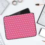 Light Pink laptop sleeve with a repeating white star pattern, shown against a bright background. laptop sleeve kept on a plain white background