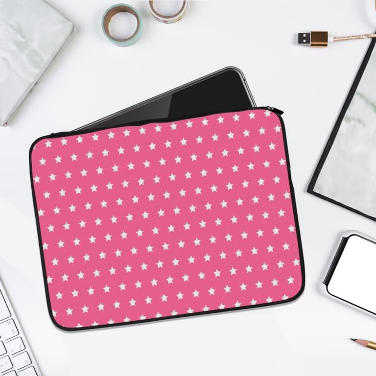 Light Pink laptop sleeve with a repeating white star pattern, shown against a bright background. laptop sleeve kept on a plain white background