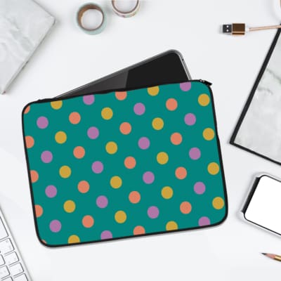 Playful pastel polka dot design laptop sleeve with yellow, purple, and orange dots on a teal background. laptop sleeve kept on a plain white background