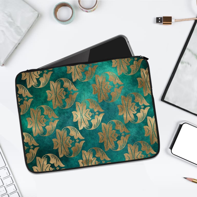 Elegant floral teal-blue laptop sleeve with beige and gold flowers, offering stylish protection for your laptop. laptop sleeve kept on a plain white background