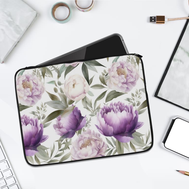 Elegant floral laptop sleeve with purple flowers and green leaves on a soft, light background. laptop sleeve kept on a plain white background