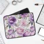 Infidu Elegant Floral Laptop Sleeve with purple and pink flowers, green leaves, and a soft white background, offering stylish laptop protection. laptop sleeve kept on a plain white background