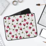 Infidu Floral Pink & Green Laptop Sleeve with pink flowers and green stems on a white background, offering protection and style. laptop sleeve kept on a plain white background