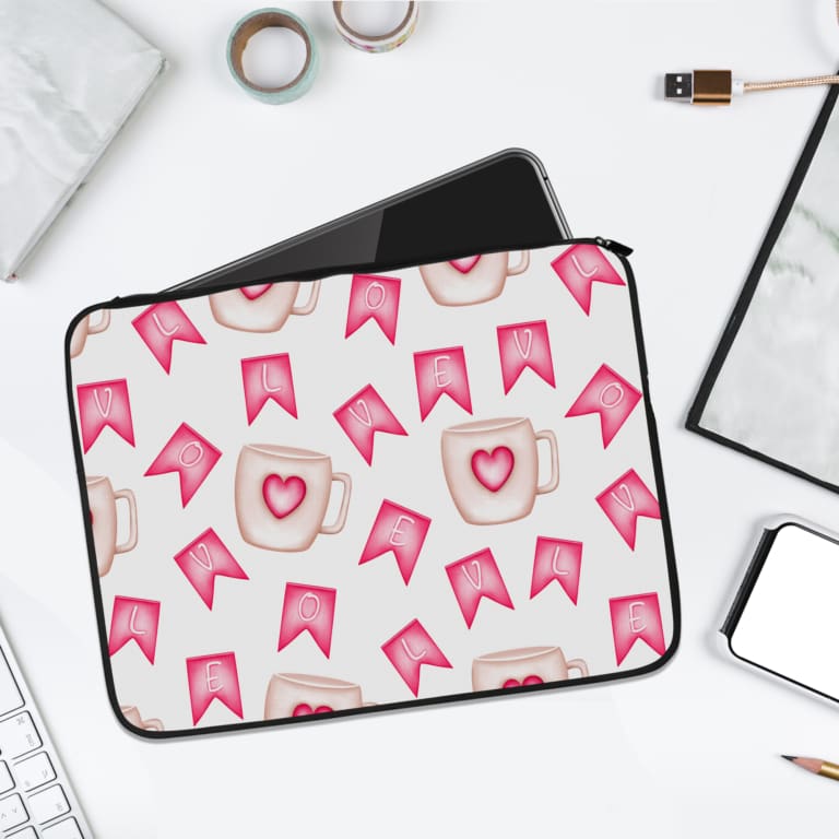 Light laptop sleeve with pink heart, ribbon, and beige mug pattern on a light background. laptop sleeve kept on a plain white background