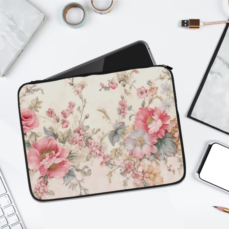 Vibrant pink floral laptop sleeve with large flowers, smaller blooms, and green leaves, offering stylish and elegant protection for your laptop. laptop sleeve kept on a plain white background