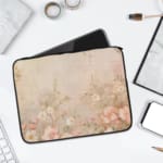 Beige laptop sleeve with subtle floral pattern, featuring a zip closure for secure protection. laptop sleeve kept on a plain white background