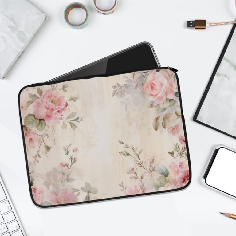 Elegant soft pink floral vintage laptop sleeve with light pink roses and green leaves on a pale background, designed for laptop protection. laptop sleeve kept on a plain white background