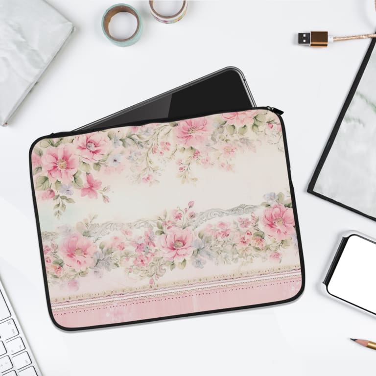 Floral laptop sleeve with pink and white flowers, black-bordered edges, soft background, and delicate floral design. laptop sleeve kept on a plain white background