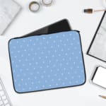 Simple blue laptop sleeve with white polka dots for a clean and stylish design. laptop sleeve kept on a plain white background