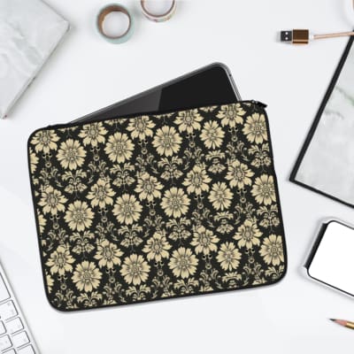 Infidu laptop sleeve with gold floral pattern on a black background. laptop sleeve kept on a plain white background